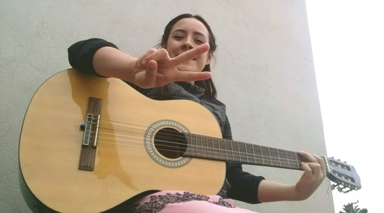 Alina with her
                            guitar
