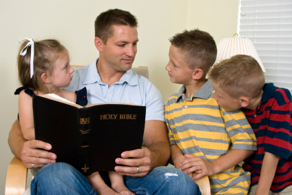 father with children
                    reading the Bible