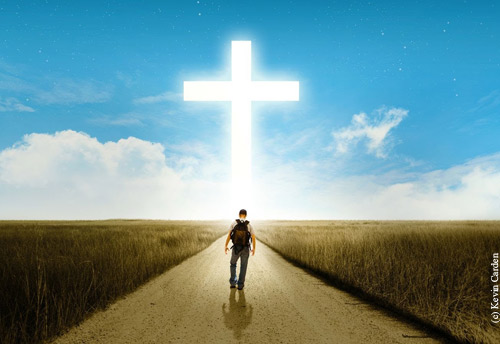 man walking towards the cross