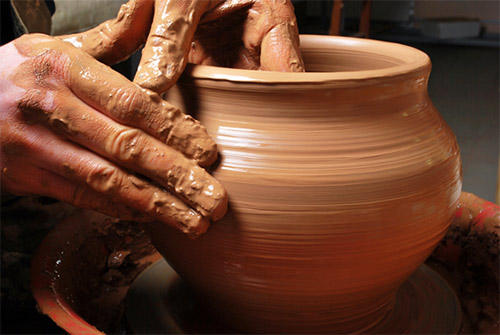 potter
                            shaping a clay pot