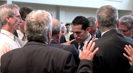 Brothers pray
                                with Noel duringt the commitment
                                ceremony