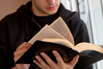 young man reading
                  Bible
