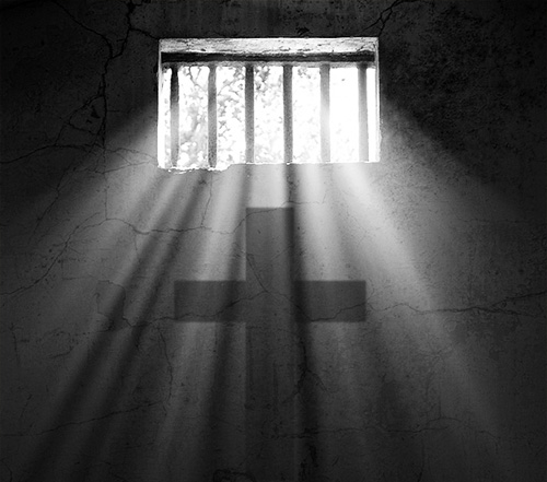 light
                  shing through prison cell window with cross