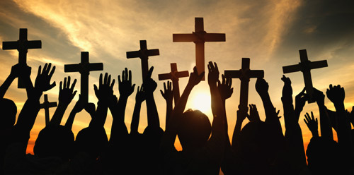 people holding
                  crosses together in prayer